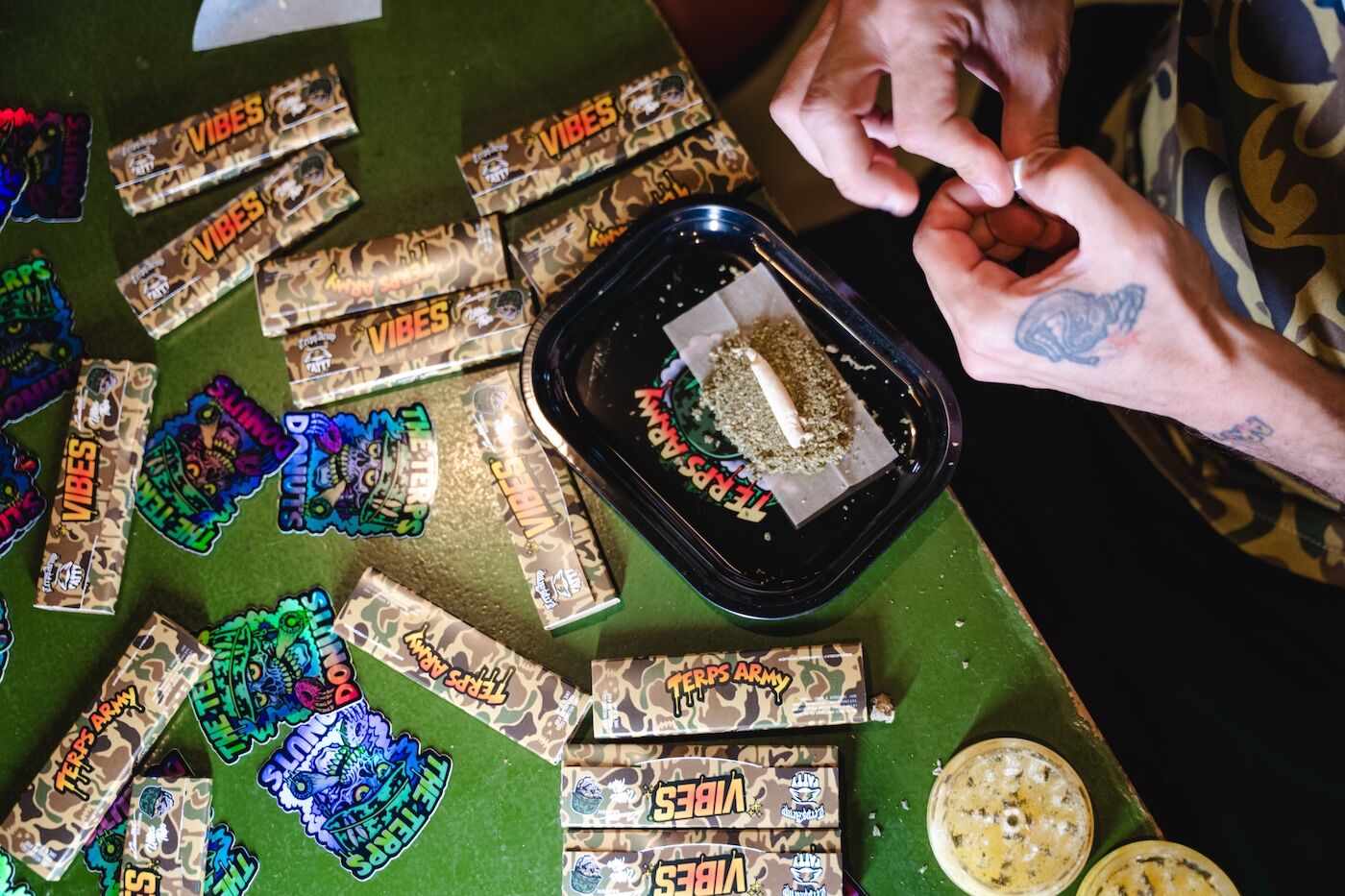 hash holes cannabis donut joints 11 man rolling a hash hole or donut joint with cannabis on a rolling tray tattooed hands