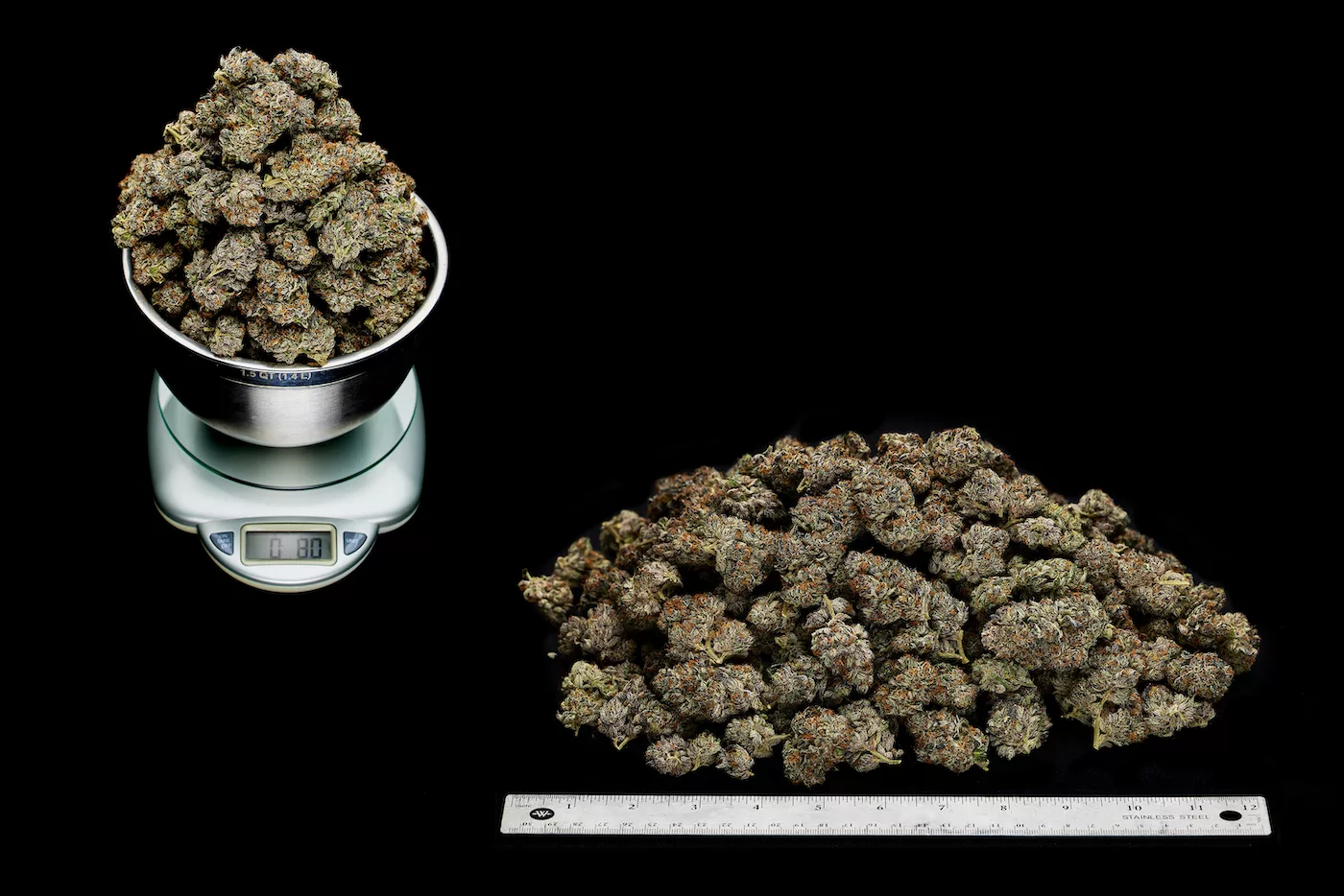1 half-pound of weed 1 half-pound of cannabis nugs on scale and next to measuring ruler